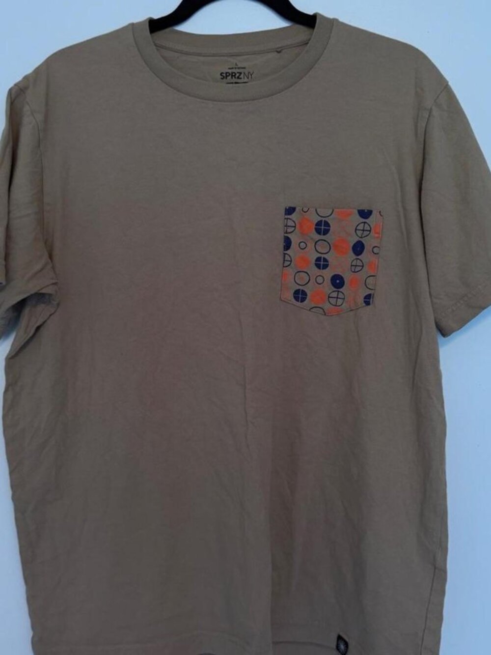 Uniqlo SprzNY pocket tee with orange and black geometric pattern, size L